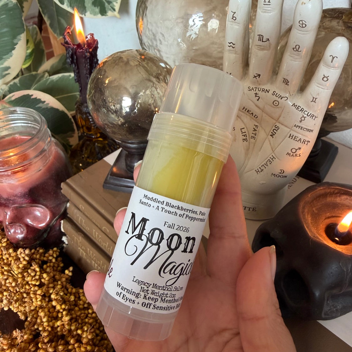 Moon Magick Legacy Menthol Salve held in hand, showing the Fall 2026 scent label