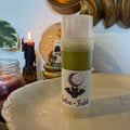 Salve + Fable 2oz salve stick with storybook bat logo label, styled with candle and skull snow globe