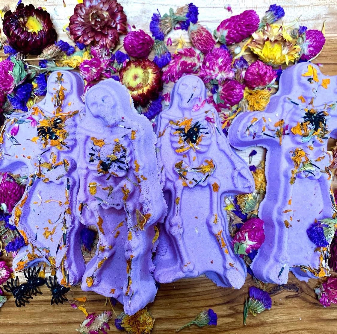 Spooky Scary Skeletons bath bombs, lavender skeleton figures with marigold petals among dried flowers