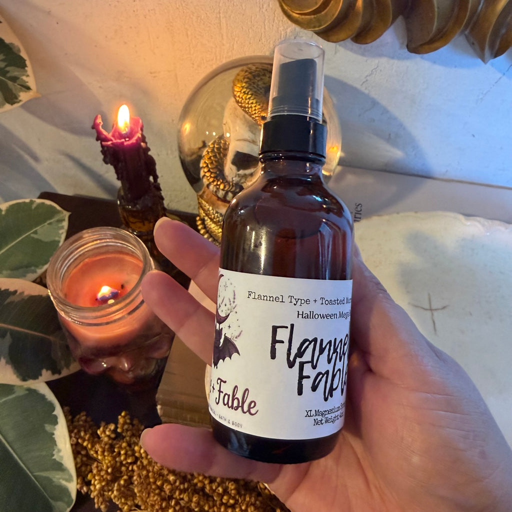 Flannel + Fable XL magnesium spray held in hand, showing the scent label