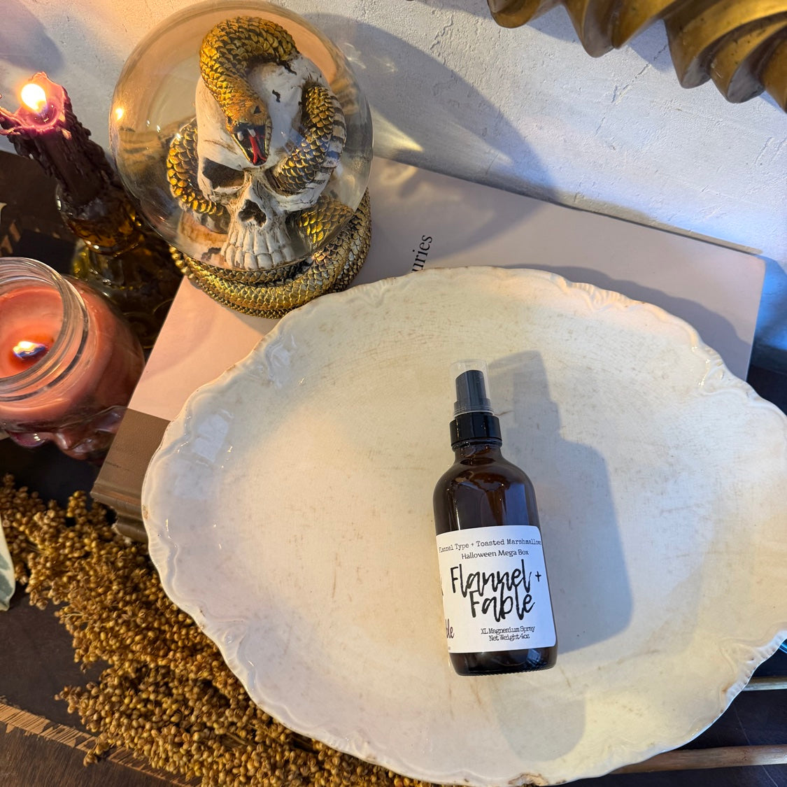 Flannel + Fable XL magnesium spray on a vintage white plate with skull snow globe and candles